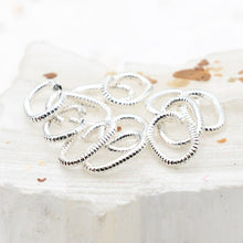 Load image into Gallery viewer, Sterling Silver Plated 9mm Textured Oval Jump Rings - 12pcs
